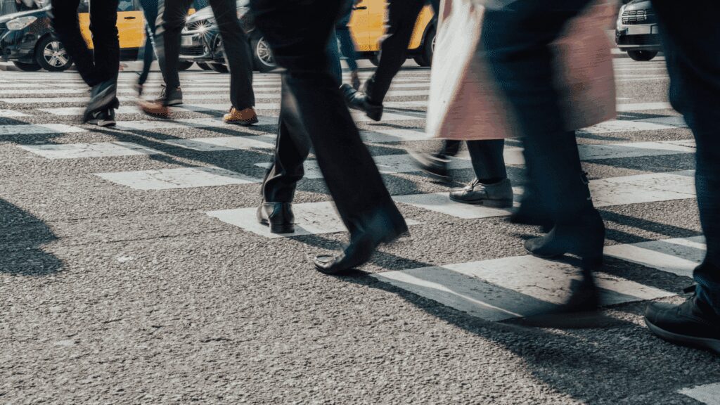 Close-up of commuters' feet on crosswalk