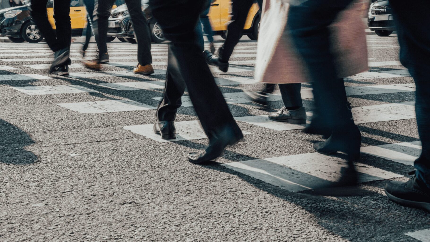 Close-up of commuters' feet on crosswalk