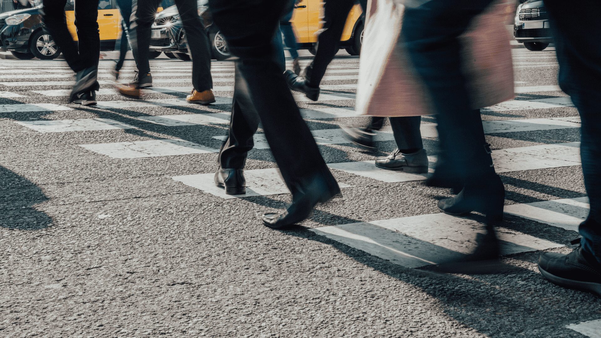 Close-up of commuters' feet on crosswalk